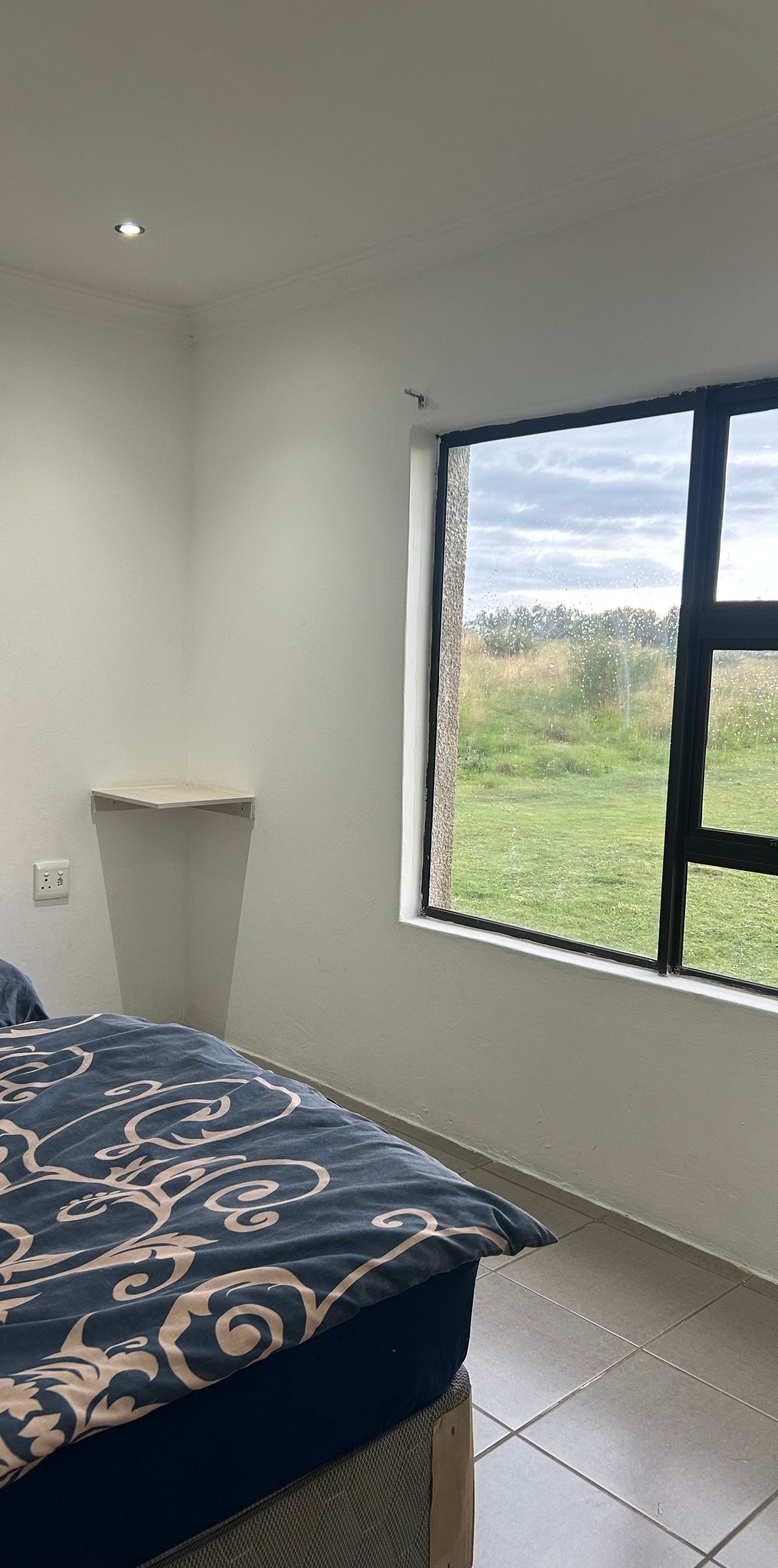 The chalet bedroom, with a window over the veld