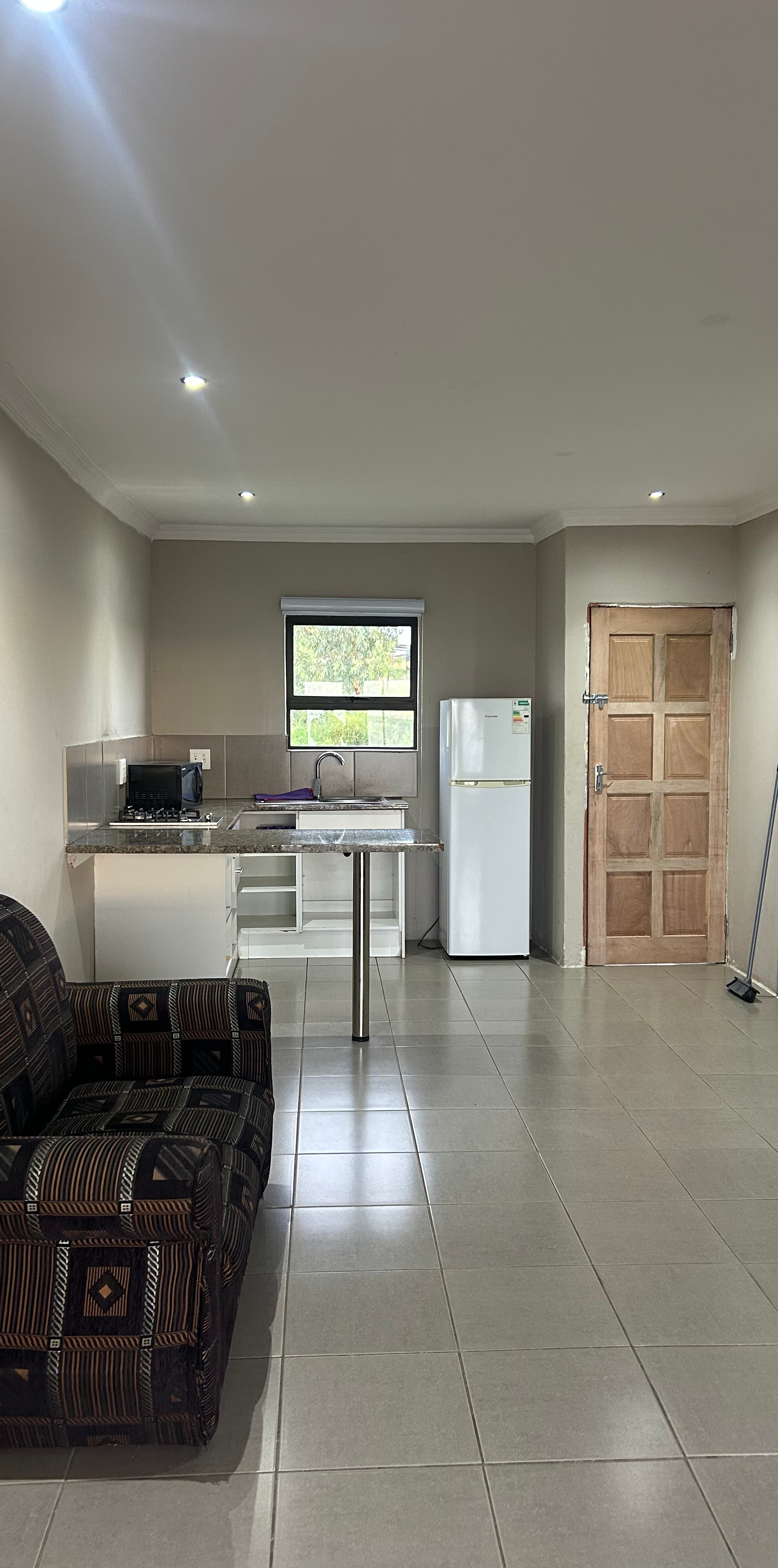 Inside the chalet — open-plan living area and equipped kitchen